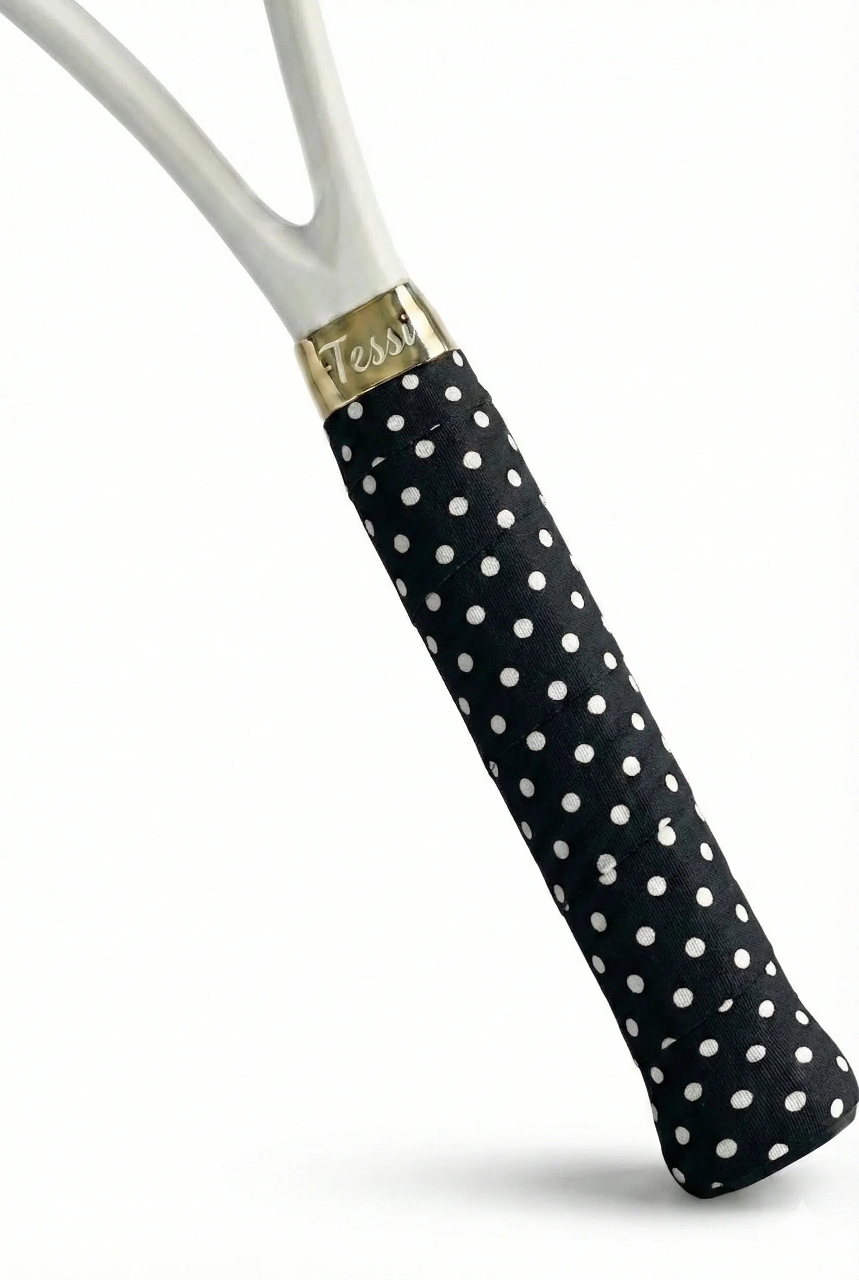 TESSI black and white polka dot overgrip on a white racket studio shot