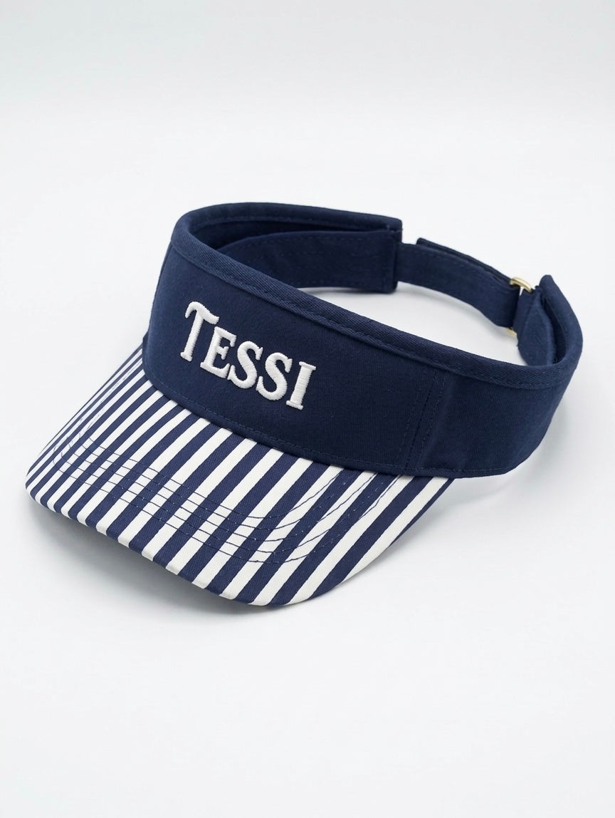 TESSI navy visor with embroidered wordmark and blue-white striped brim