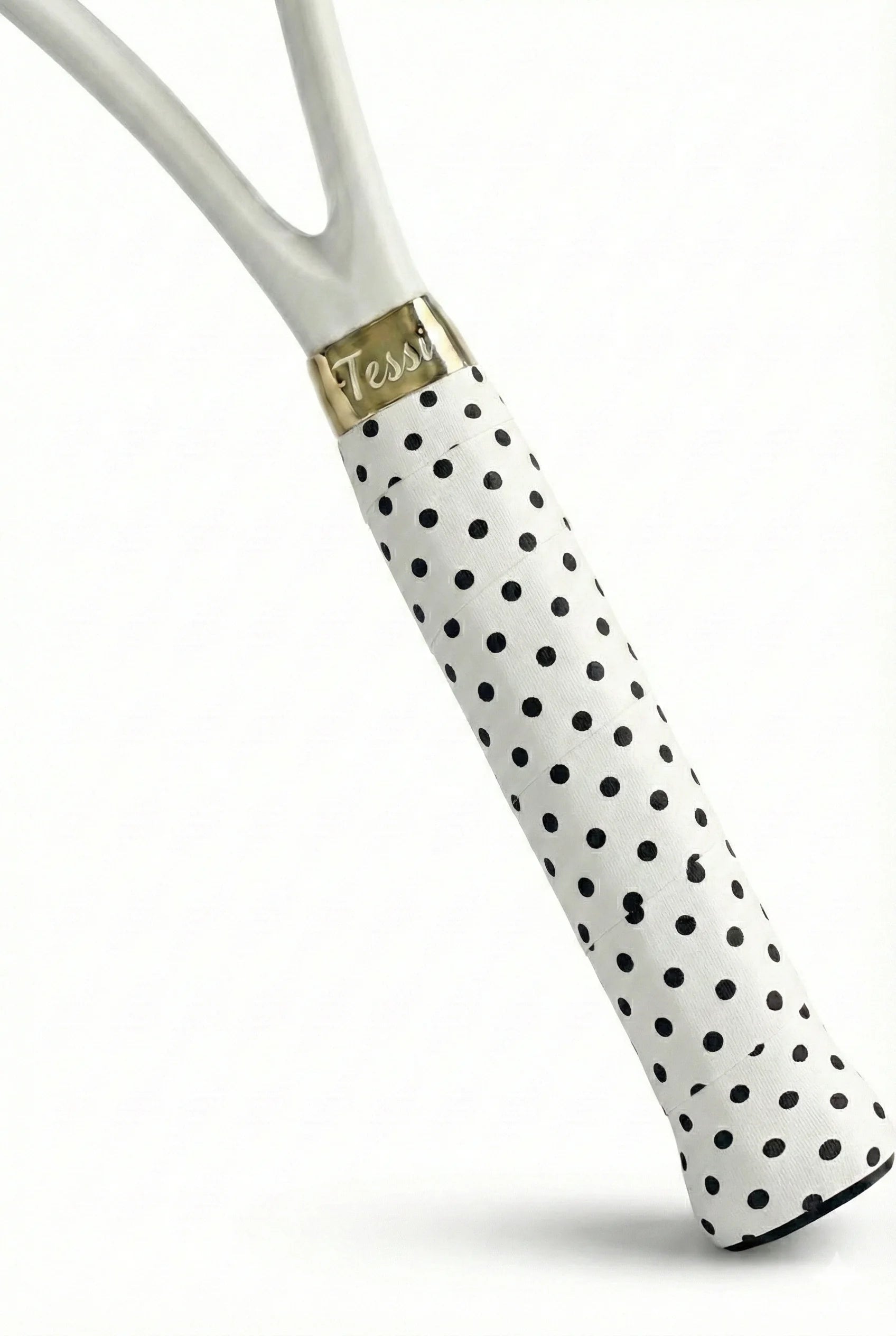 TESSI black and white polka dot overgrip wrapped on a white racket